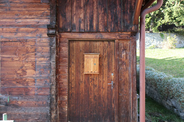 The Modern wooden door with metal door handle over the white wall. -Image