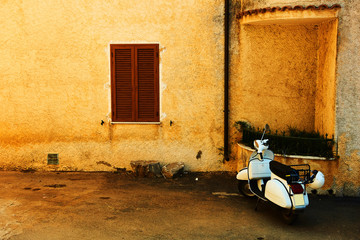 postcard from Italy with a moped and an orange wall © Dorota