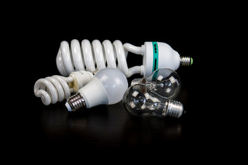 Different light bulbs isolated on the black table