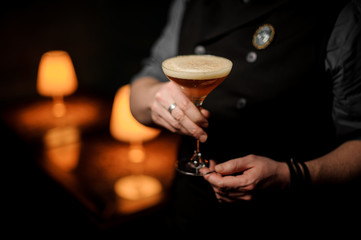 Professional bartender serving cocktail with a whipped cream and grated nutmeg - obrazy, fototapety, plakaty