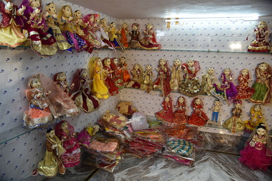 group of Hand Crafted & Fine Painted Wooden Pair Of Gavar & Ishar placed on room shelf
