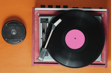 Retro style, pop culture attributes on orange background. Vinyl player,speaker. Top view, flat lay
