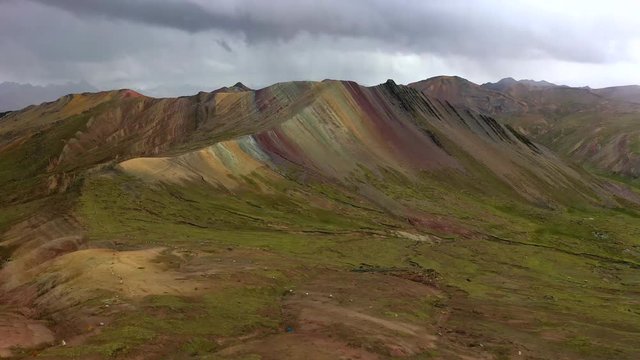 Aerial drone panoramic view of the rainbow colored mountain and huge Andes peaks of Peru, Latin America