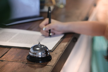 woman guest at the reception of  hotel checking in.