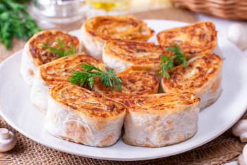 Fried lavash rolls with potatoes and mushrooms