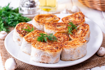 Fried lavash rolls with potatoes and mushrooms