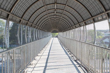 Overpass with roof and protection mesh metal fence.
