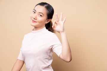 Happy woman showing OK gesture isolated on background