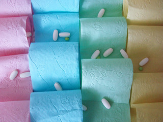Colored toilet paper and pills on it