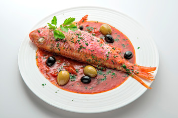 Dish with mullet fish tomato and parsley