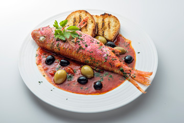 Dish with mullet fish tomato and parsley