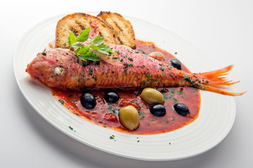 Dish with mullet fish tomato and parsley
