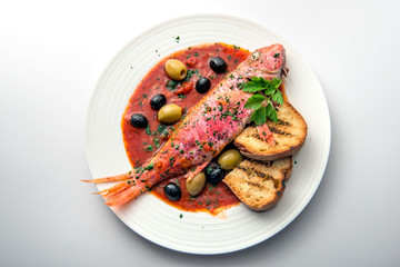 Dish with mullet fish tomato and parsley