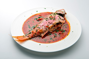 Dish with mullet fish tomato and parsley