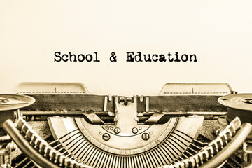 School and education printed on a sheet of paper on a vintage typewriter. writer, journalist.