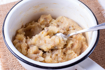 Potato filling for pies in a pan on a wooden table