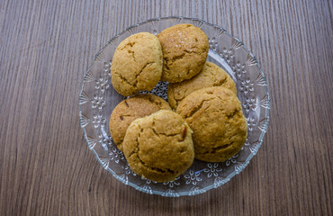 Sweet cookies isolated on wooden table background. Homemade cookies or biscuits or shortcakes in a plate. Beautiful pastry snacks of Turkish culture. Enjoy concept photo. A plate with handmade snacks.