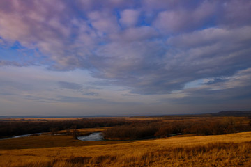 River in autumn field