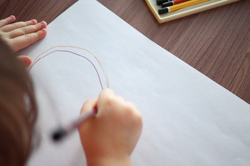 blurred of child draws with pencils, top view