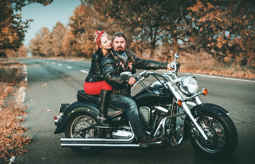 Obraz na płótnie Canvas Happy bikers on motorcycle on the road.