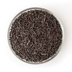 Dried black tea in glass bowl isolated on white background with clipping path