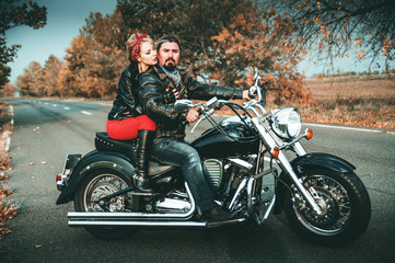 Fototapeta na wymiar Happy bikers on motorcycle on the road.
