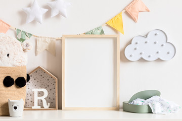 Stylish and modern scandinavian newborn baby interior with mock up photo or poster frame on the...