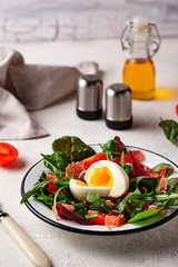Healthy salad with prosciutto, tomato and egg