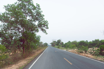 Fototapeta premium Empty asphalt road and clean blue sky in summer day background with copy space