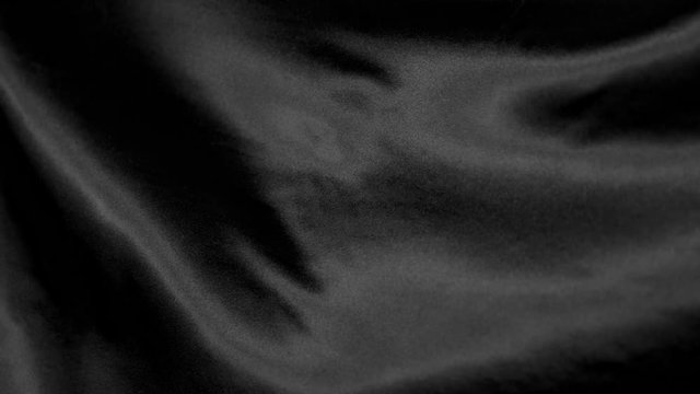 Black wavy fabric background in super slow motion, 4K