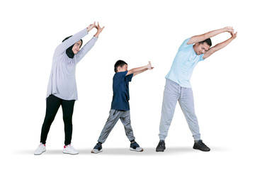 Little boy doing hands stretch with his parents