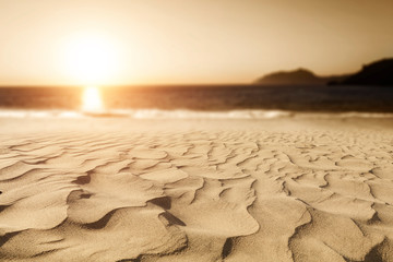 Summer background of sand on beach and blue sky with sun light. Free space for your decoration. 