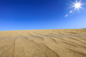 Plakat Summer background of sand on beach and blue sky with sun light. Free space for your decoration. 
