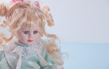 Cute vintage doll on the blue background