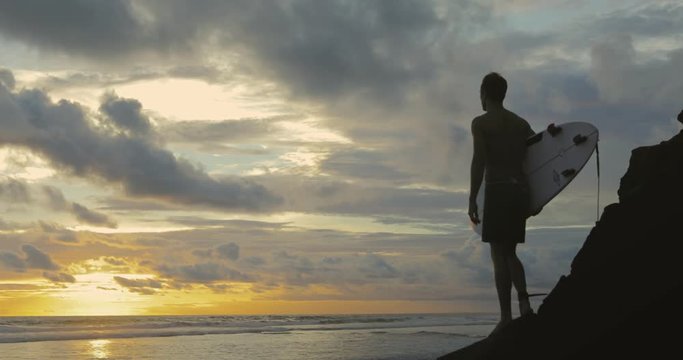 Portrait of surfer looking at waves