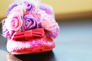 Fototapeta na wymiar Toddler's shoes in roses, girl icon, photo