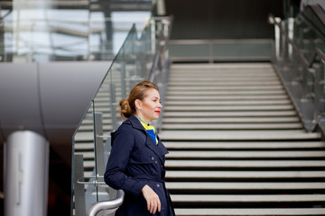 Fototapeta premium beautiful stewardess in the airport terminal looks out the window