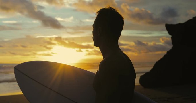 Portrait of surfer looking at waves