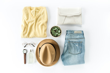 Woman clothes and accessories set on white background top view. modern and casual outfit. fashion, shopping and makeup concept. Flat lay, top view. 