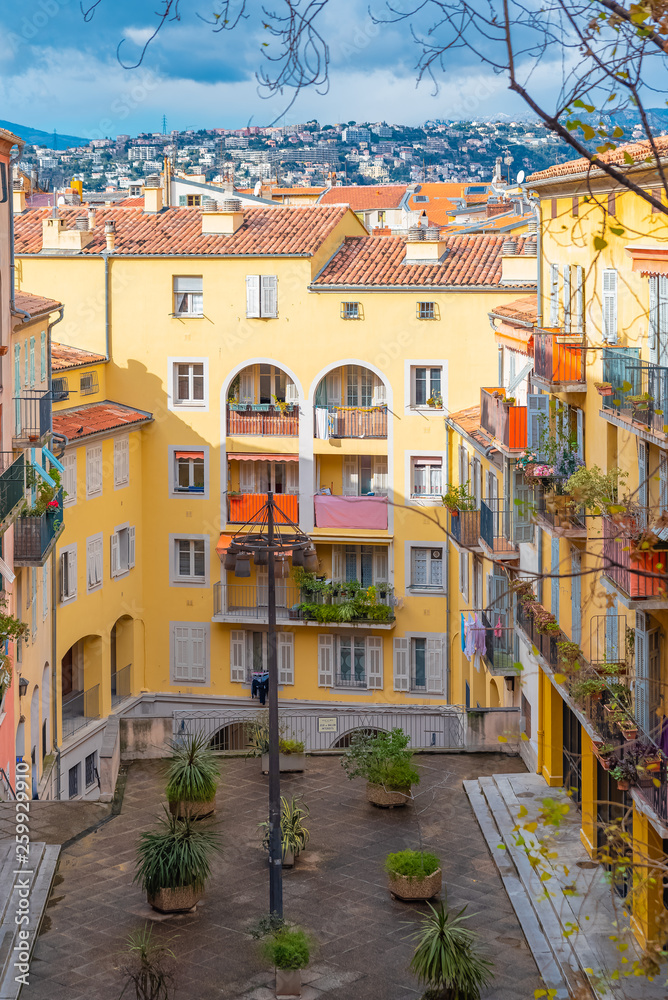 Wall mural Nice in France, building yard with typical colorful facades in the old town, French Riviera 