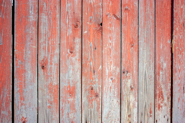 Wooden boards with old red paint.  Exfoliation paint on old boards. Old wood wall. Texture