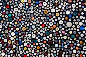 background - multicolored buttons on a dark surface