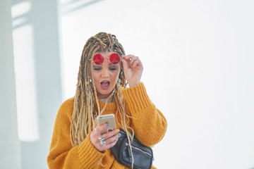 Portrait of wondered woman, excited student, shocked girlfriend having smart phone cellphone in...