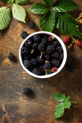 Berries ripe blackberries on kitchen wooden table. Top view flat lay background, copy space.