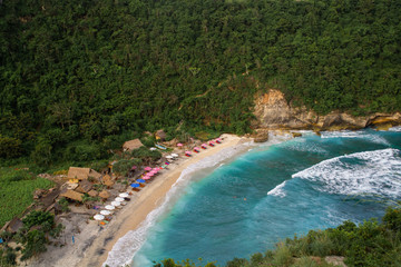 2018_1_19 Nusa Penisa, BALI. Aerial or Top view of colorful Atuh beach. Turquoise water, white sand beach, warm sunlight, sun loungers and parasols. Tourist popular destination/attraction in Indonesia