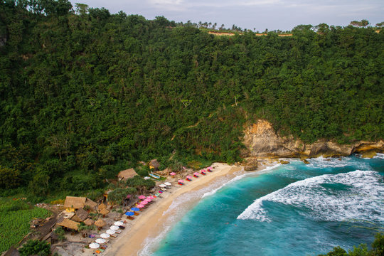 2018_1_19 Nusa Penisa, BALI. Aerial or Top view of colorful Atuh beach. Turquoise water, white sand beach, warm sunlight, sun loungers and parasols. Tourist popular destination/attraction in Indonesia