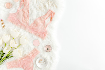 Flat lay set of sexy, lacy, pink lingerie, accessories on white background. Top view.
