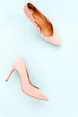 Pastel pink women high heel shoes on blue background. Flat lay, top view trendy fashion feminine background. Beauty blog concept. Fashion blog look. 