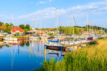 Fototapeta na wymiar Sailing boats anchoring at lake shore in Seedorf port, Baltic Sea, Rugen island, Germany