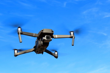 Flight of the drone against the blue sky.